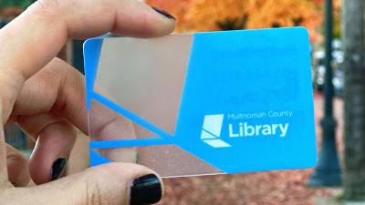Hand holding library card