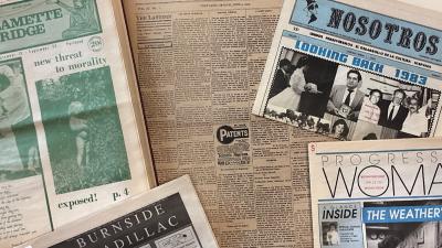 Newspaper issues of Willamette Bridge, The Lantern, Nosotros, Burnside Cadillac and Progressive Woman newspapers, laid out on a table on top of each other.