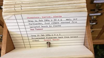 A card in the library’s local newspaper index, with citations for articles about a 1964 shipwreck in Alaska. 