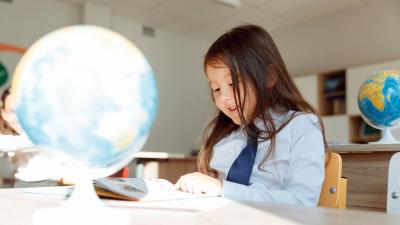 A child reads at a desk.