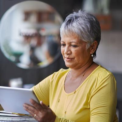 Older woman reading on an ipad