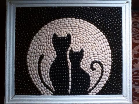Image of two black cats made out of beans
