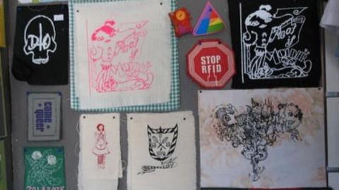 various handmade patches displayed on a wall