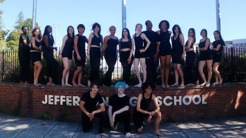 group of dancers against a blue background