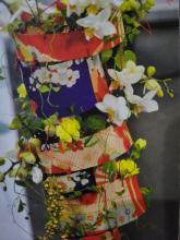Orchid arrangement inside patterned fabric 