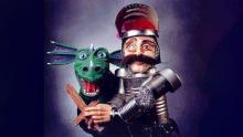 Image of a green dragon puppet and a mustachioed knight puppet