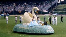 An image of an early Rose Festival float with a swan