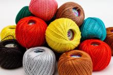 Photo of many different colored balls of thread