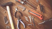Photo of many different repair tools laid out on a table