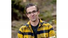 Photo of Brian Trapp in a yellow, navy and white plaid button up flannel.