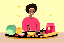 A woman whisking something in a bowl, surrounded by fresh cooking ingredients 