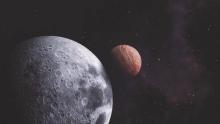 Image of the moon and a planet almost aligned in space.