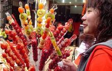 Photo of person looking at candied hawthorn