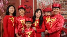 Photo of Dean TranDinh with his family in red attire.