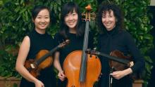 photo of three musicians in black with their instruments