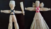 Photograph of two human shaped dolls of cornhusk