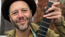 Musician with guitar smiling 