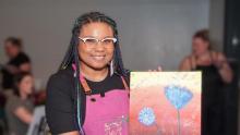 Photo of a person with their artwork made with The Lamb Art Studio