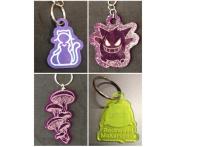 Photo collage of four different laser-cut acrylic keychains