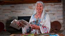 Photo of Karen Kitchen reading and smiling.