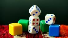 Photo of different dice and board markers stacked on each other.