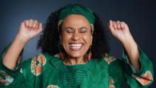 Picture of Habiba with arms up, hands and eyes closed, in animated posture mid-story