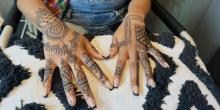 Photo of henna paste designs on hands floral and geometric