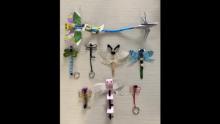 Photo of several hand crafted dragonflies with different body shapes and colors.