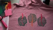 Photo of a stamped print of rainbow chard on a pink article of clothing from the King Flower Prints website.