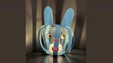 Photo of a blue crafted rabbit lantern with a glowing light inside
