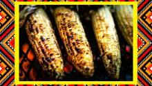 a photograph of grilled corn cob elotes in front of a colorful geometric border