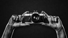 photo of a camera held in two hands