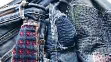 Photo shows jeans mended with star and dash style embroidery