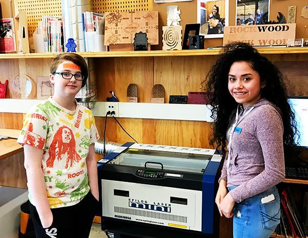 Two teens standing next to 3-D printer at Rockwood Makerspace