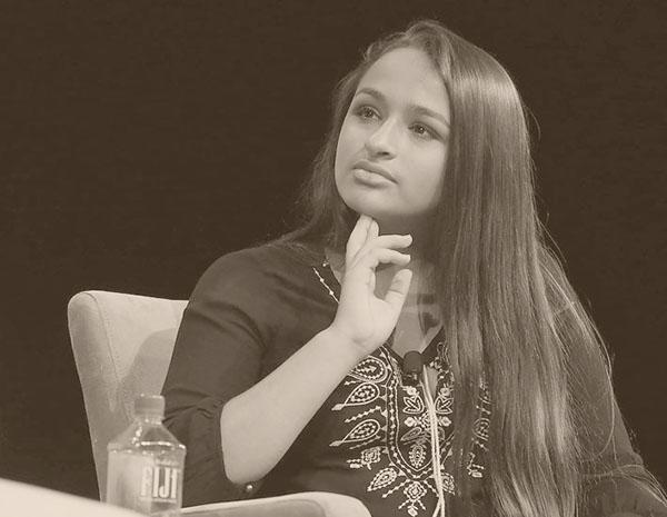 Jazz Jennings looking off to side with one hand holding chin up