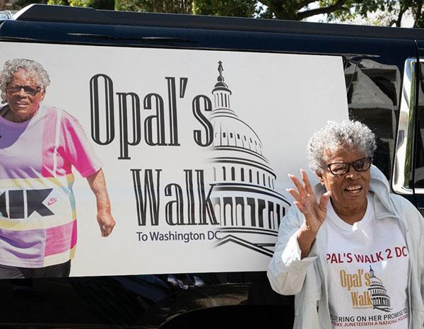Opal Lee waving to crowd on her walk