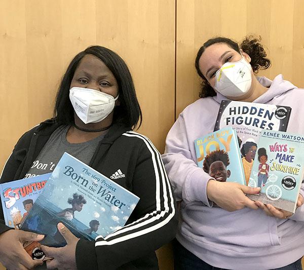 Tamara Stigler and Kariisa Allen, BCLAs at Hollywood Library, holding up kids' books.
