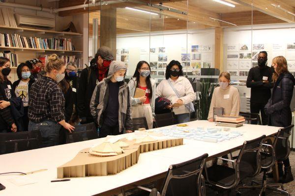 Members of the youth design group look at design ideas