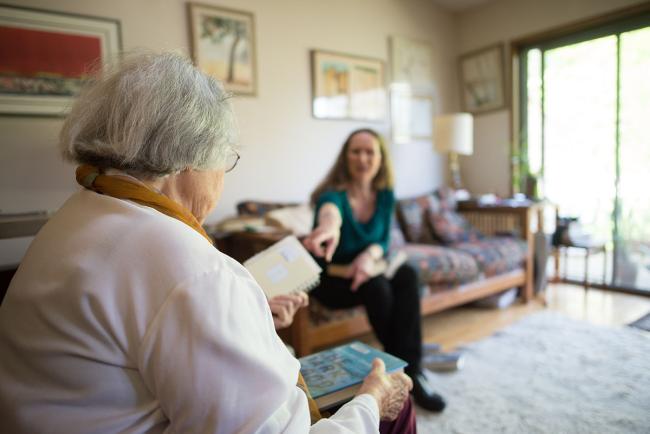 Library employee visiting with a patron in their home
