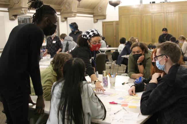 Architects, staff and teen participants work on an activity for the Youth Opportunity Design Approach program