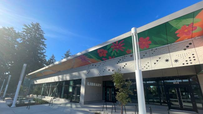 Outside of the building of the new Midland Library, large windows and entryway with multiple doors.